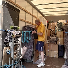 man and van driver is loading moving goods to van